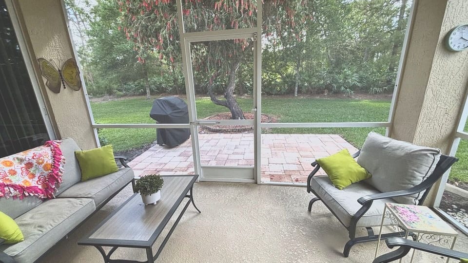 Enjoy bug-free outdoor living in the spacious, screened-in lanai. This peaceful spot overlooking the lush green lawn is perfect for morning coffee or evening relaxation.