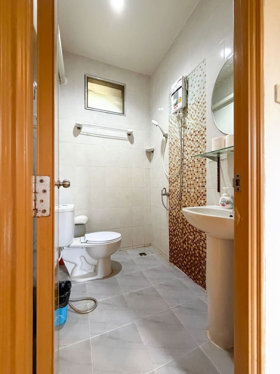 Modern bathroom with hot shower and essential amenities.