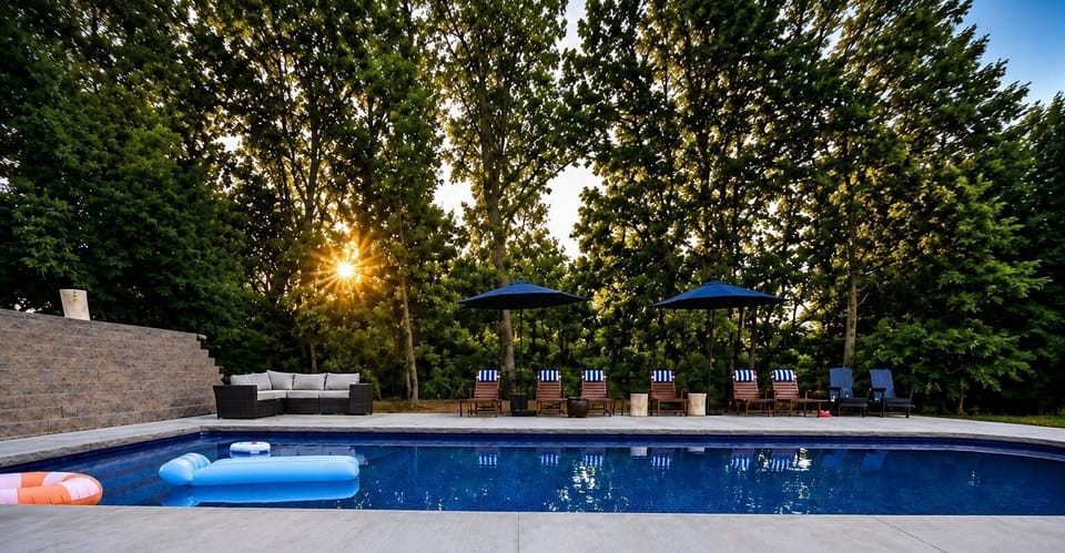 Private pool oasis with shaded loungers and serene wooded surroundings