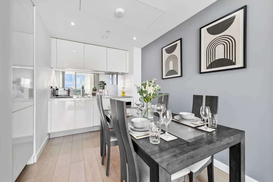 Dine and cook with ease in this stylish space featuring a sleek dining table and a well-equipped kitchenette—perfect for convenient, comfortable stays. | Photo tags: Kitchen