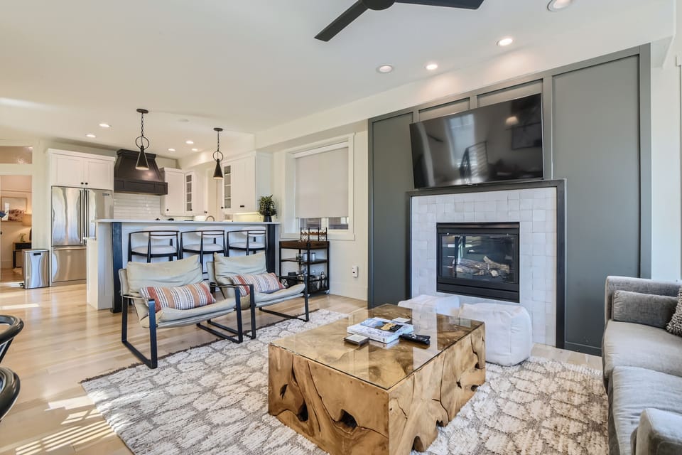 Gather in this stylish open-concept living space featuring a sleek fireplace, designer finishes, and a chef-inspired kitchen.
