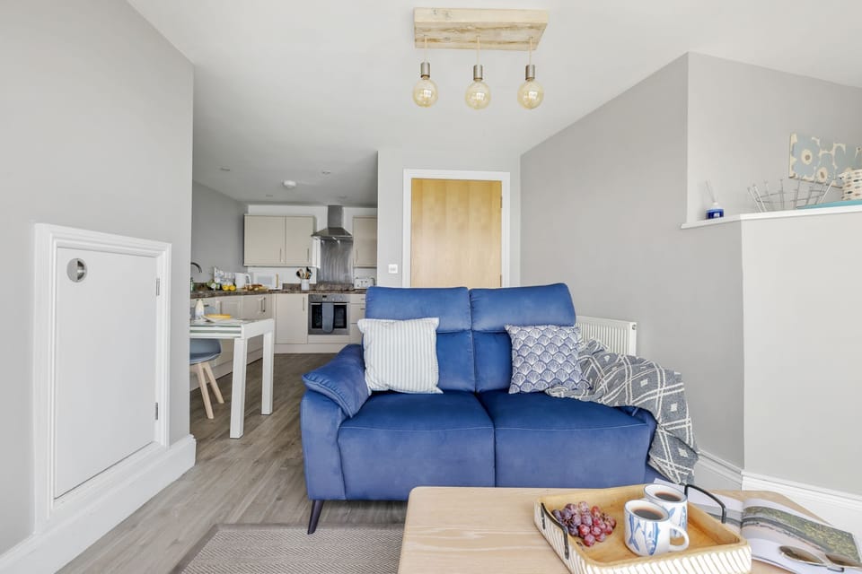 Sofa, coffee table and dining area leading to kitchen - Marina View Suite