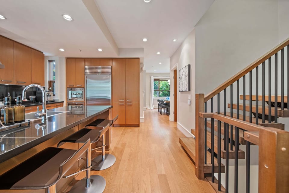 Kitchen - Sleek breakfast bar seating for casual meals, high-end appliances throughout