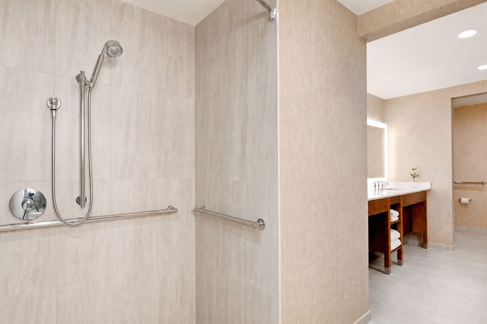 Refresh in a clean, spacious bath with bright vanity lighting.