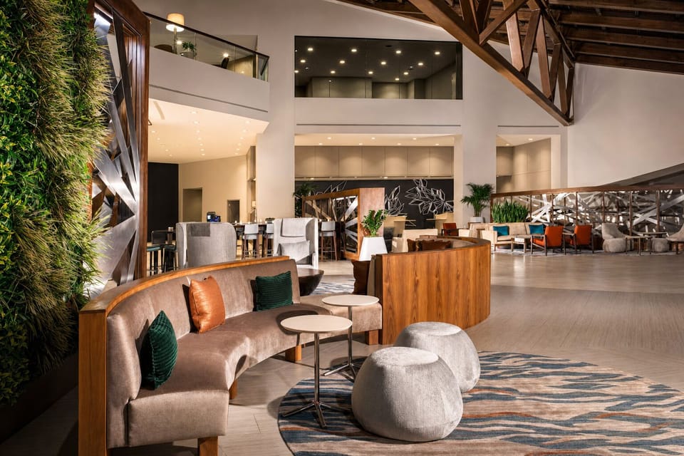 Sink into plush seating under warm, ambient evening lighting.