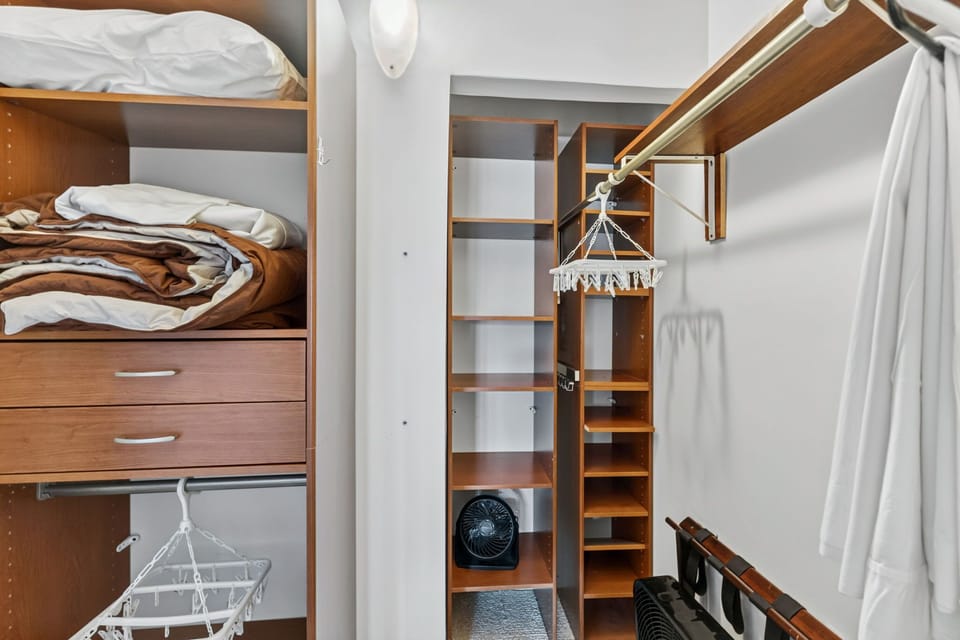 Find plenty of room for your belongings with generous closet space featuring wooden shelving, drawers, and hanging storage to keep your getaway organized and stress-free.