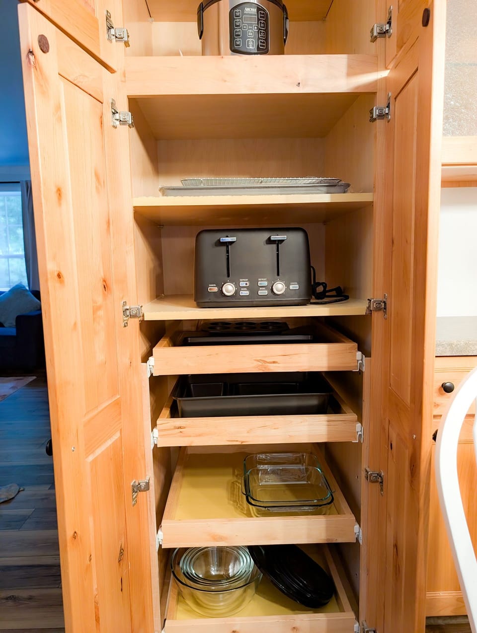 Well-stocked kitchen pantry with pull-out shelves and cooking essentials