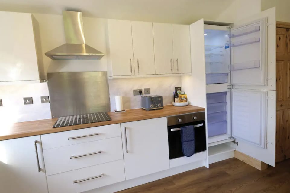 Pendragon kitchen and full size fridge freezer