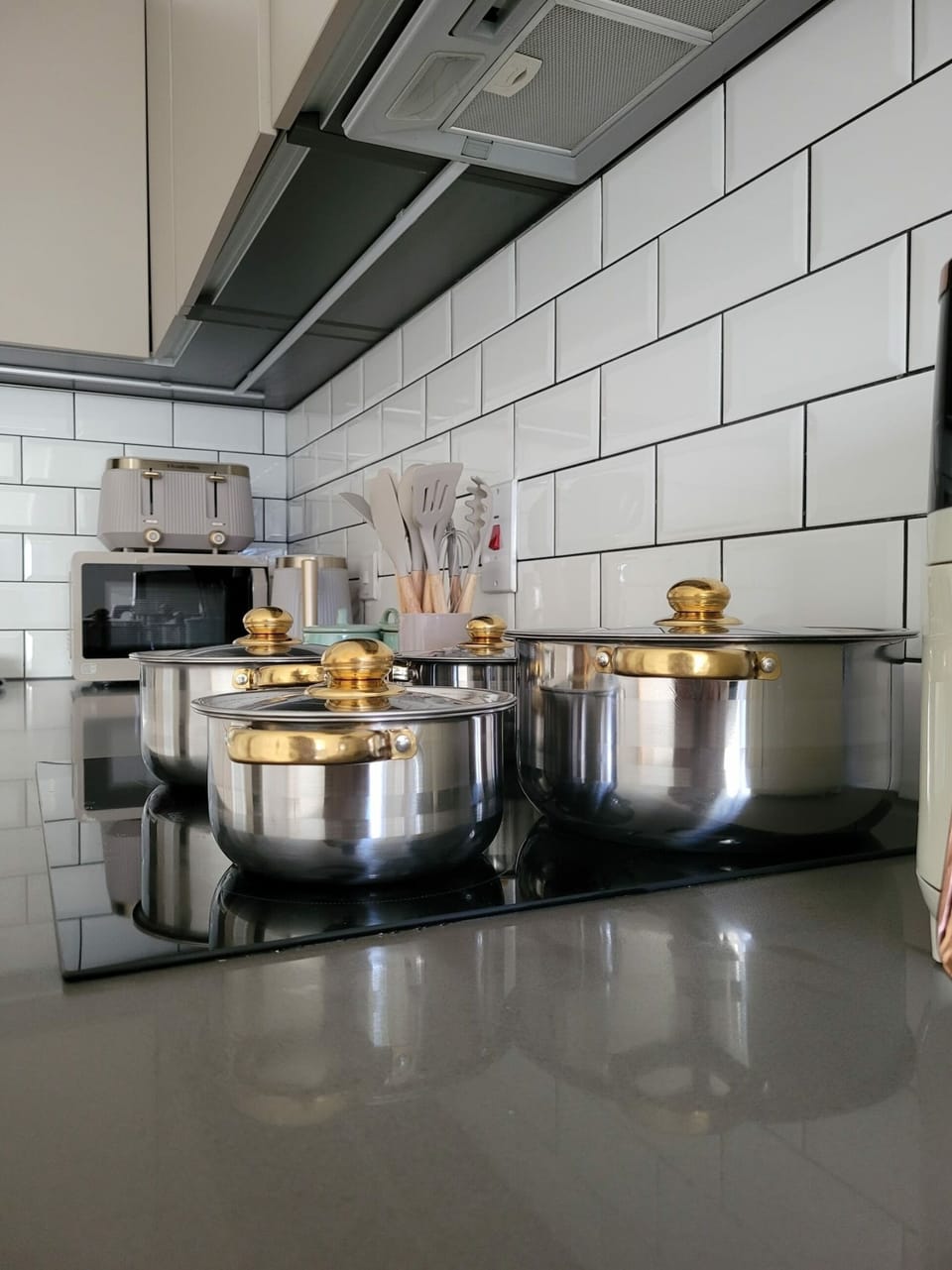 The kitchen features all essential appliances for a fully functional space, with cookware carefully chosen for various cooking styles.