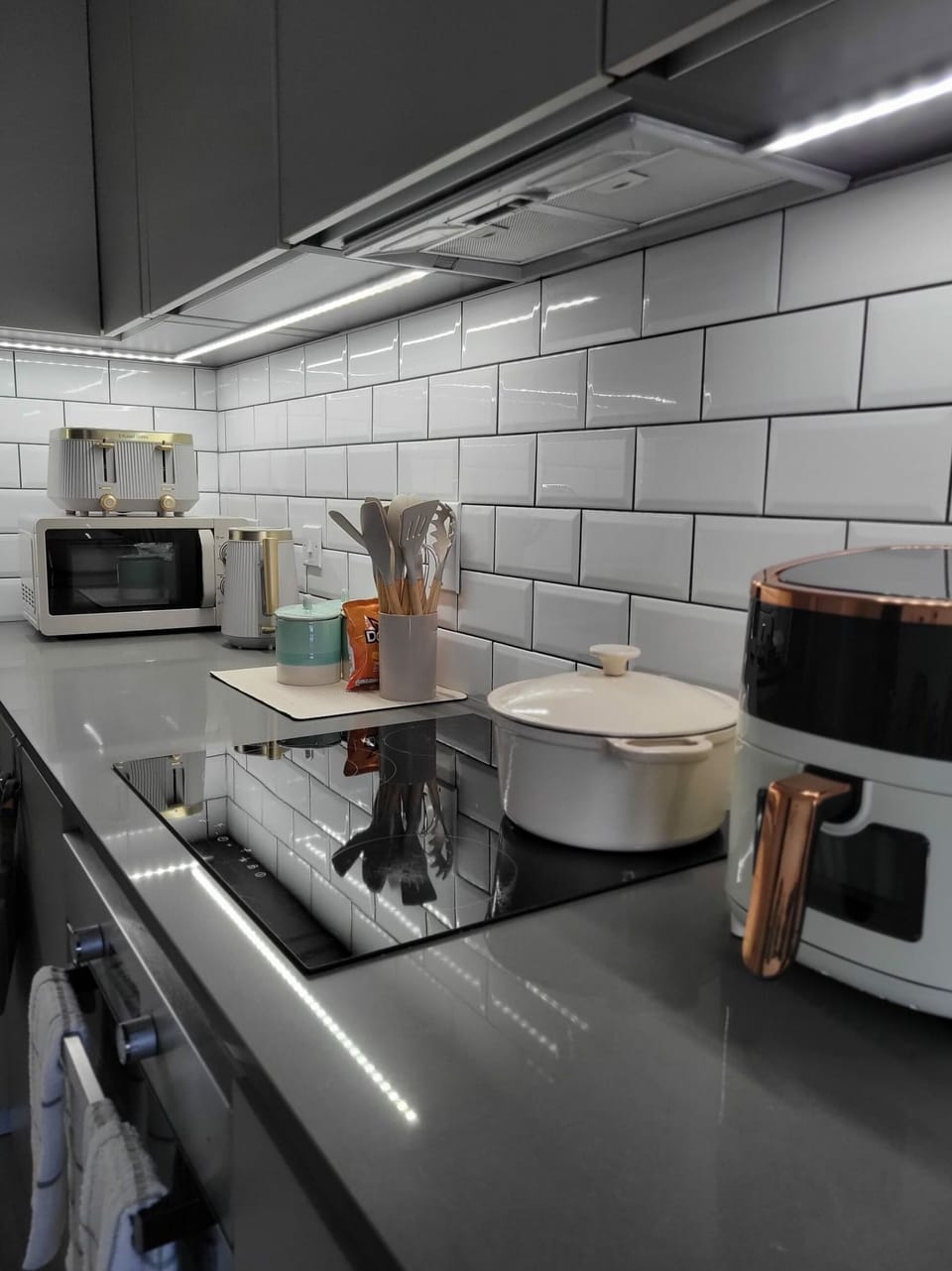 Experience a beautifully illuminated night-time kitchen equipped with all essential appliances, offering a fully functional and convenient space. Bright, vibrant colours create a warm, welcoming atmosphere where guests can relax and enjoy their stay comfortably.