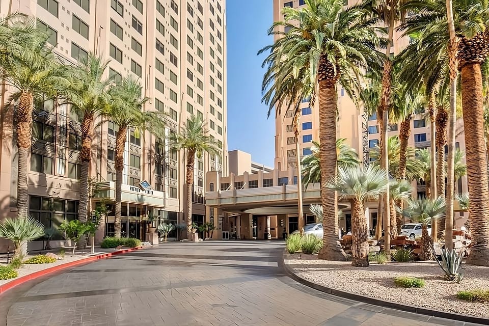 Arrive in style beneath palm-lined porte-cochère and bright skies.