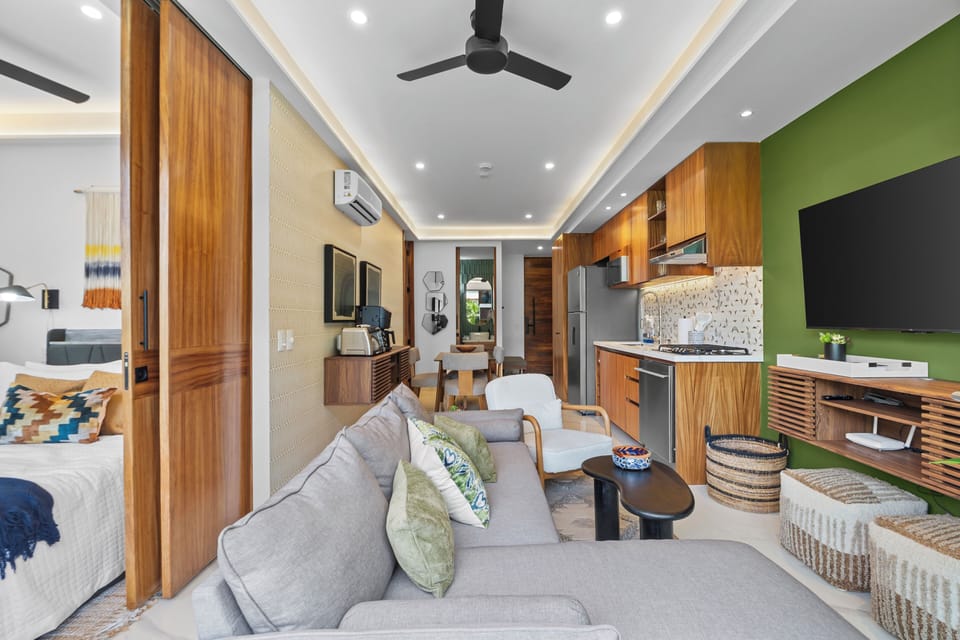 Bright modern suite with open living area and sleek wood-accent kitchen
