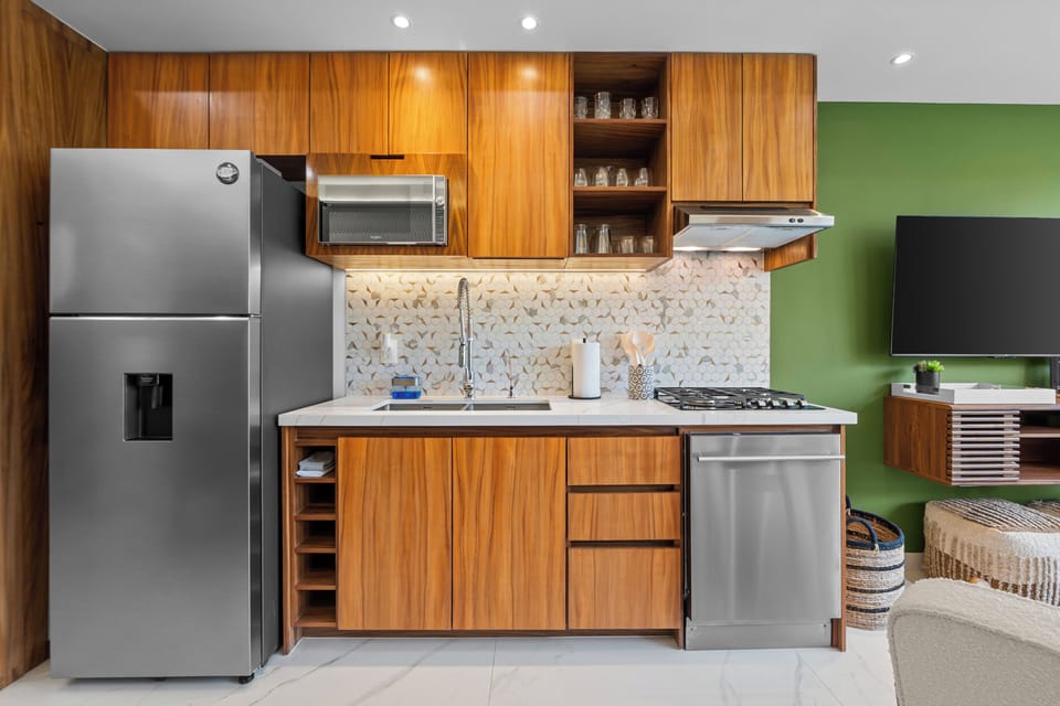 Modern wood kitchen with stainless appliances and bright open-plan style