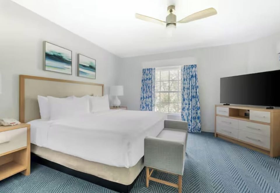 Unwind in a bright king bedroom with fresh linens.