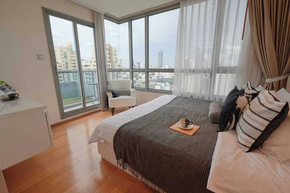 【Bedroom 1 - King Bed】Rest in luxury on the king-sized bed, positioned to offer stunning corner views and panoramic vistas outside. The room also includes a spacious walk-in closet for added convenience and comfort