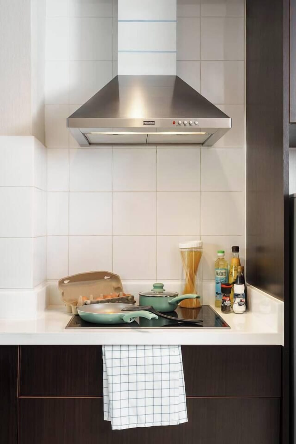 Fully equipped kitchen with stove, microwave, fridge, cookware, and essentials like oil, pepper, and salt. Donki Mall’s Japanese market is just a short walk away for more groceries.