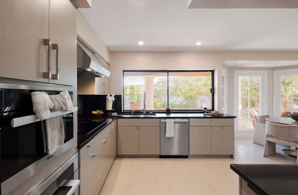 Modern chef’s kitchen featuring premium appliances, sleek cabinetry, and a bright dining nook, offering a stylish space to prepare and enjoy your favorite meals.
