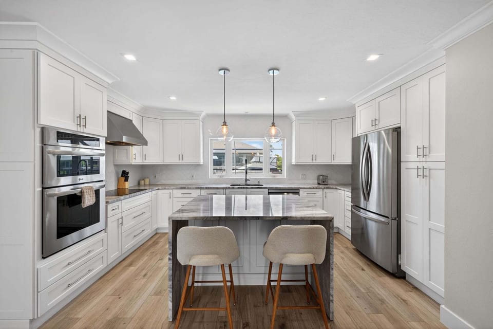 Kitchen with stainless steel appliances and breakfast bar