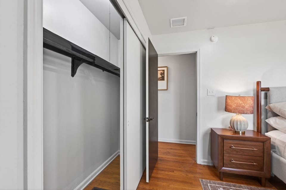 Bright bedroom with mirrored closet and generous storage space