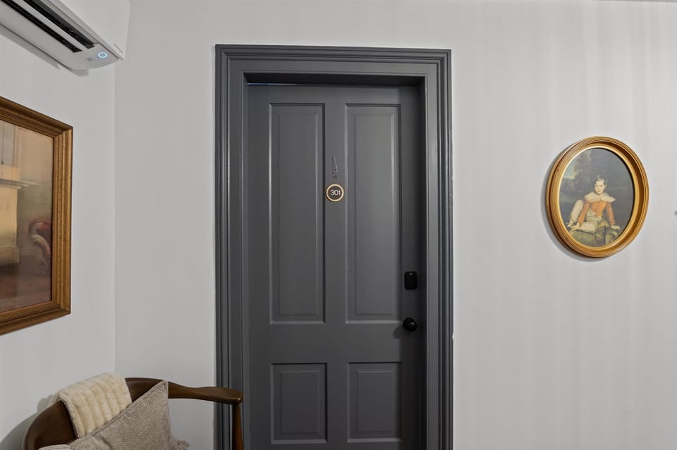 Door to unit, punch in personalized code into smart lock for entry 