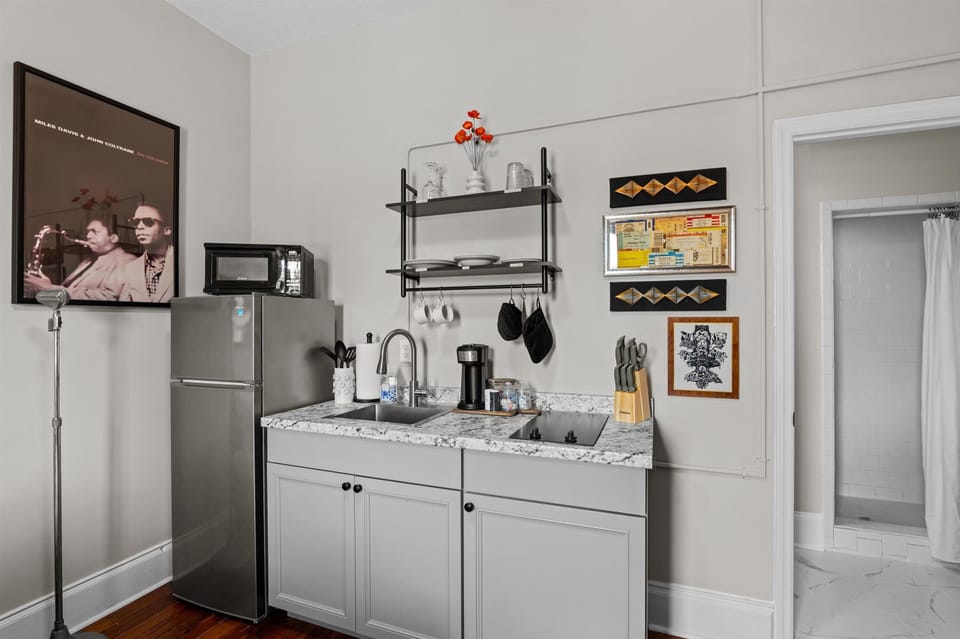 Kitchenette complete with coffee maker, microwave, fridge, and double burner