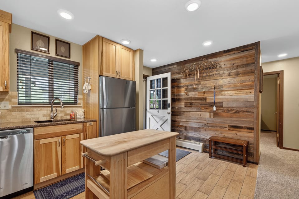 Step into a warm, rustic space where your vacation meals come together easily. Natural wood and modern stainless appliances blend perfectly, creating a welcoming retreat you'll love coming home to after exploring.