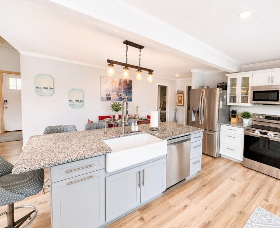 Modern open-concept kitchen with granite countertops, stainless steel appliances, and spacious island—perfect for entertaining and family gatherings.