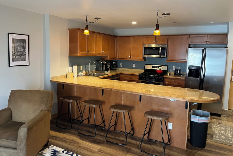 Kitchen with full size appliances, keurig and drip coffee maker and breakfast bar