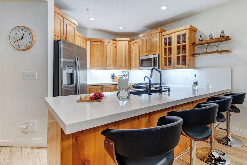 Gather around the spacious breakfast bar to prepare meals together.
