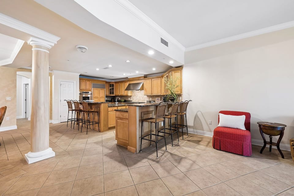 Unwind in this open, elegant space where warm wood cabinetry meets cozy seating—your home away from home for meals, conversation, and relaxation.