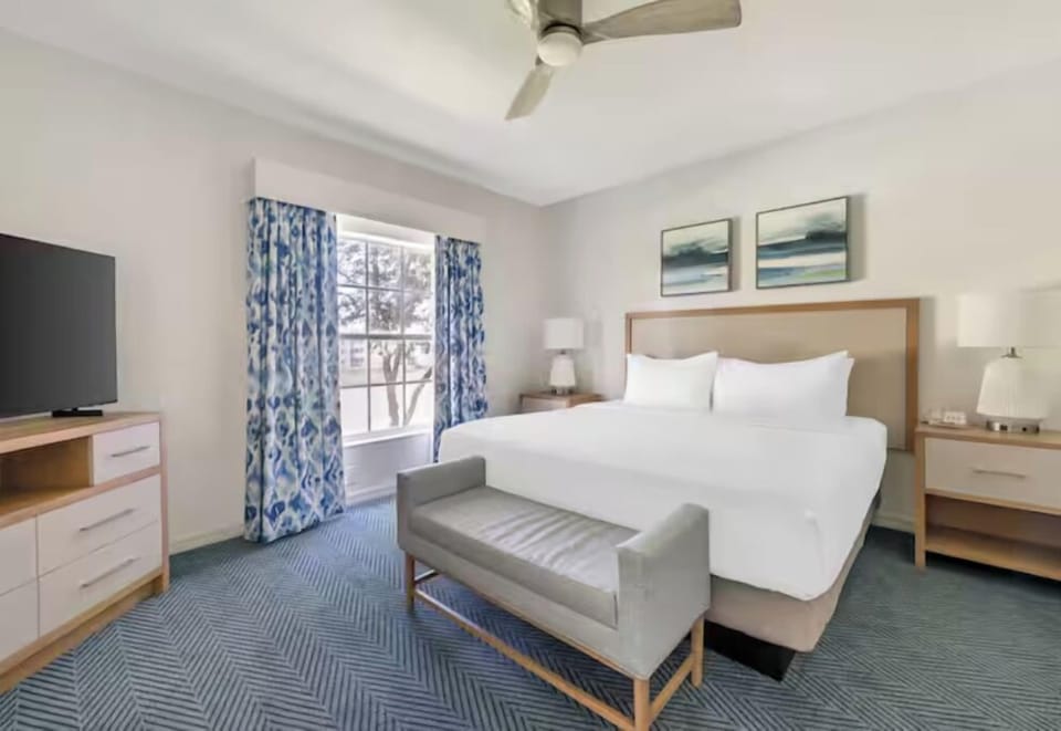 Sink into a plush king bed beside sunlit windows.