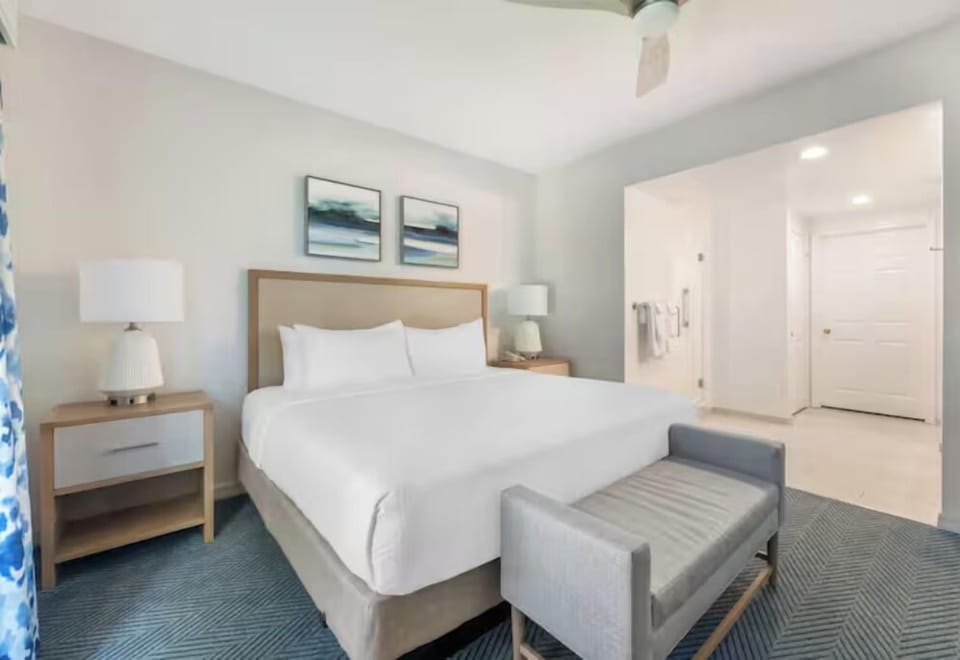 Unwind in crisp linens with bedside glow and calm.