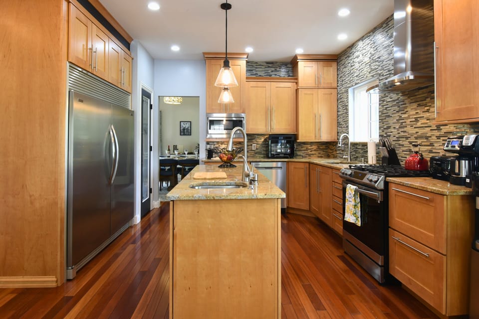 “Modern kitchen featuring stainless steel appliances, granite countertops, and a central island for cooking and conversation.”