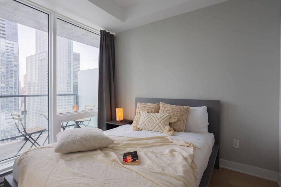 Wake up to natural light pouring in through floor-to-ceiling windows, making this space a serene urban retreat