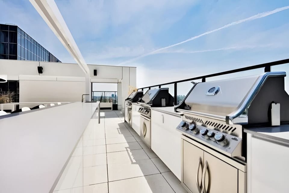 Fire up the grill and cook up a storm in this shared BBQ area, designed for guests to connect while enjoying skyline views.