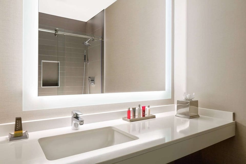 Start your day glowing with sleek vanity and rainfall shower.