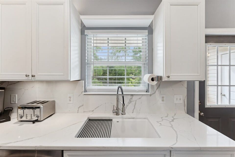 Chic farmhouse sink adds charm and function to your stay.