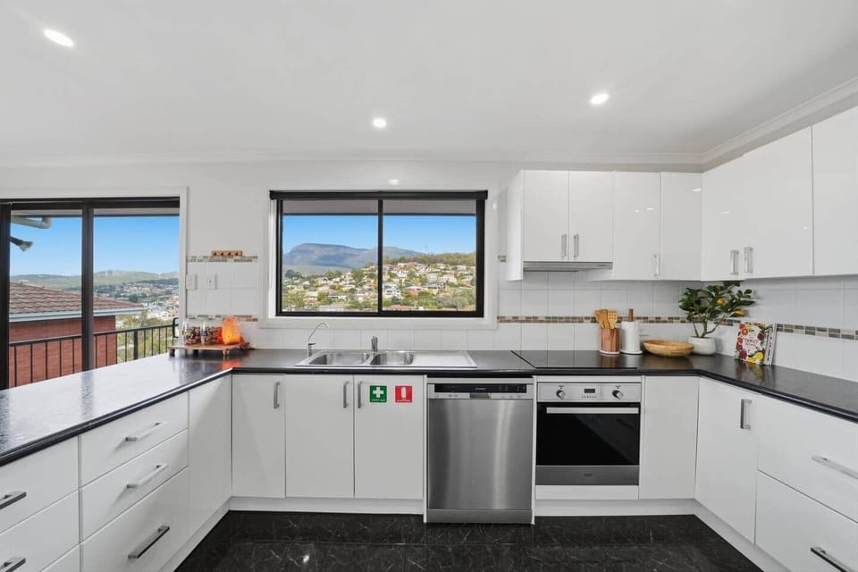 Modern kitchen featuring quality appliances, ample bench space, and cooking essentials.