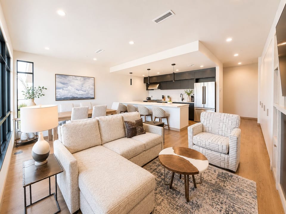 Main living space with open modern living room and kitchen. The living room features a luxury queen sofa sleeper.