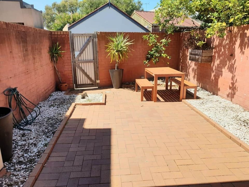 Courtyard with table and two benches which was new January 2023.