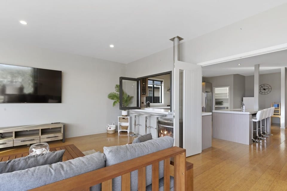 A welcoming lounge seamlessly connects to the outside space and down to the private jetty..