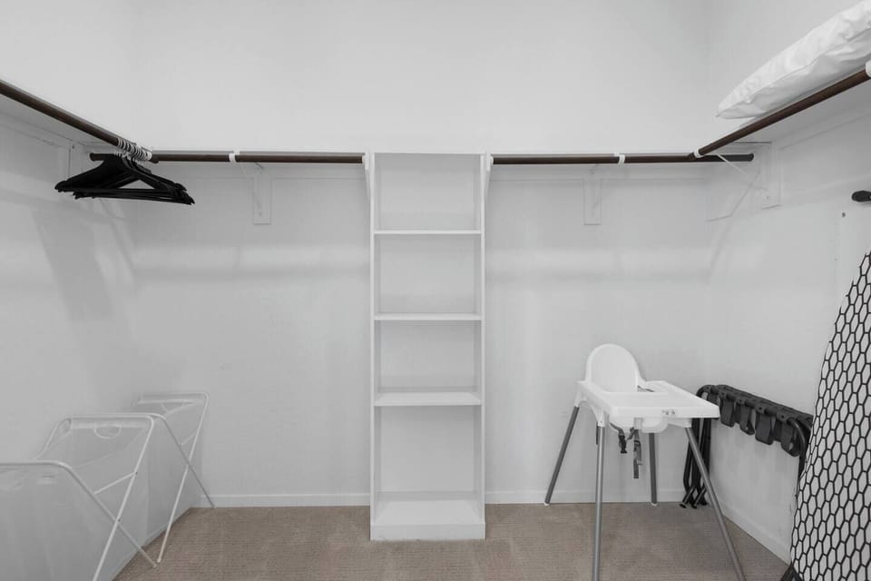 Spacious walk-in closet with ample storage, plus a cozy crib and highchair for your little one’s comfort and convenience.