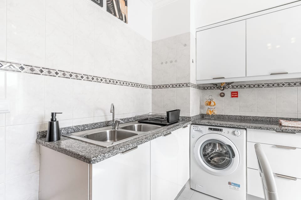 Bright kitchen with granite tops, double sink & in‑unit washer—spotless and handy.