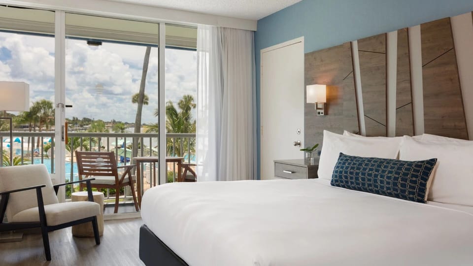 Wake up to sunlit comfort with balcony views outside.