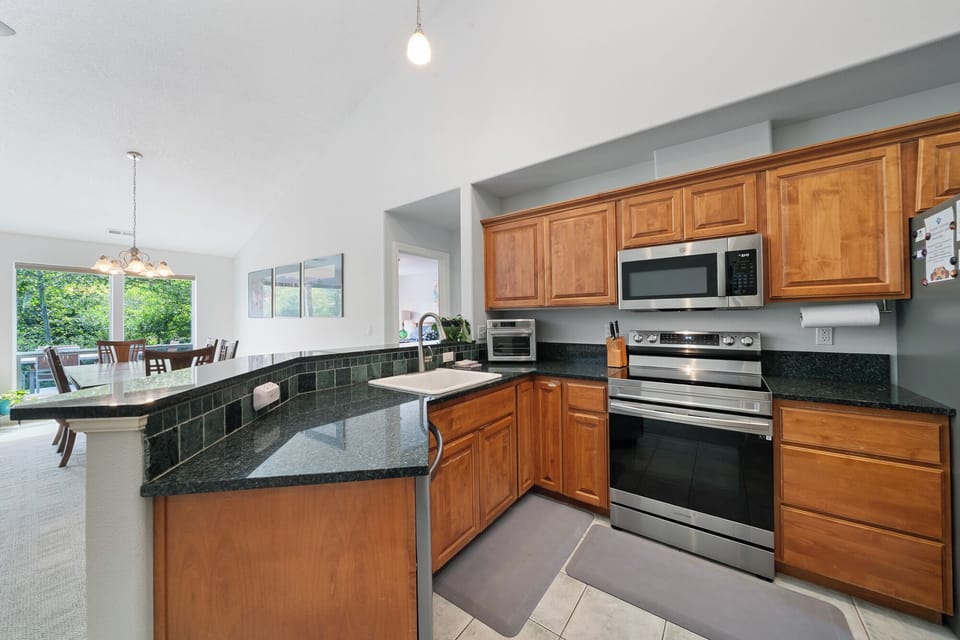 Your fully-equipped kitchen makes meal prep a breeze with granite counters, stainless appliances, and plenty of cabinet space. Enjoy coffee at the breakfast bar or gather in the dining area.