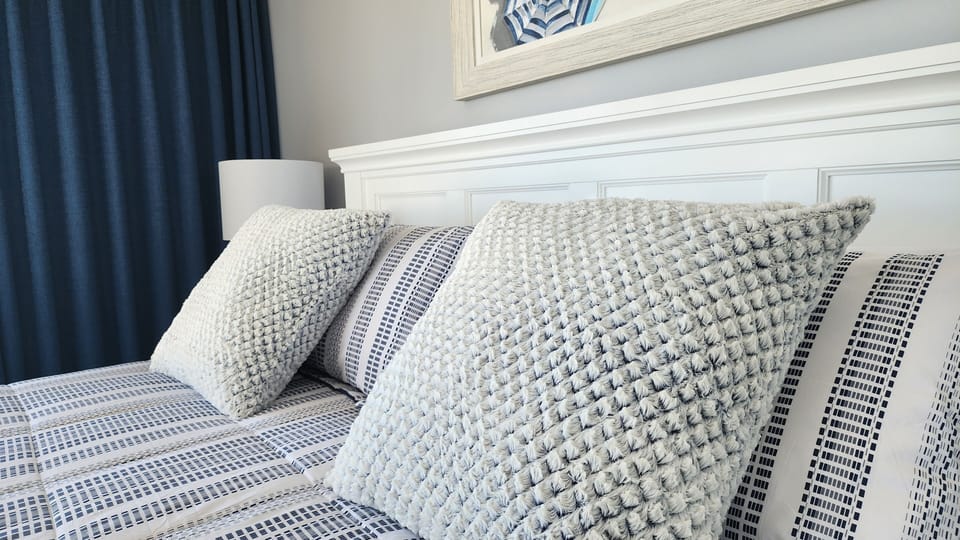 Cozy, stylish bedroom with crisp linens and textured accent pillows
