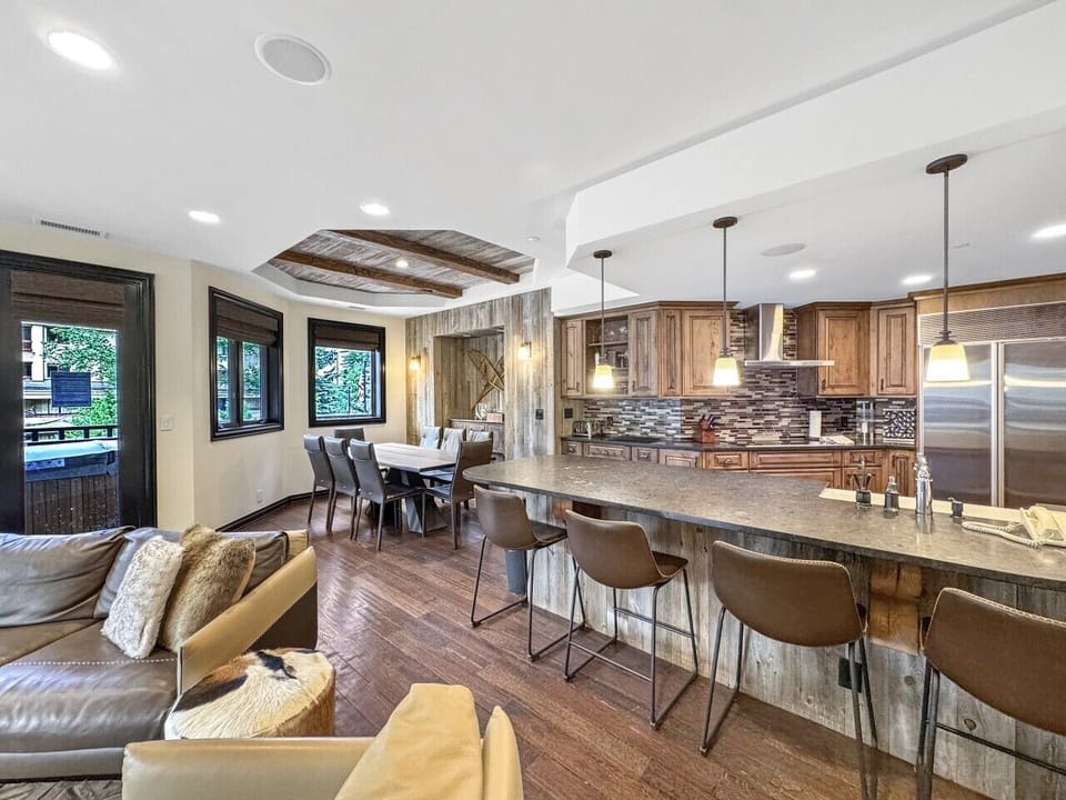 The island where everyone ends up. Four bar stools, a kitchen built for real meals, and just enough separation from the living room to make it feel like the heart of the whole condo