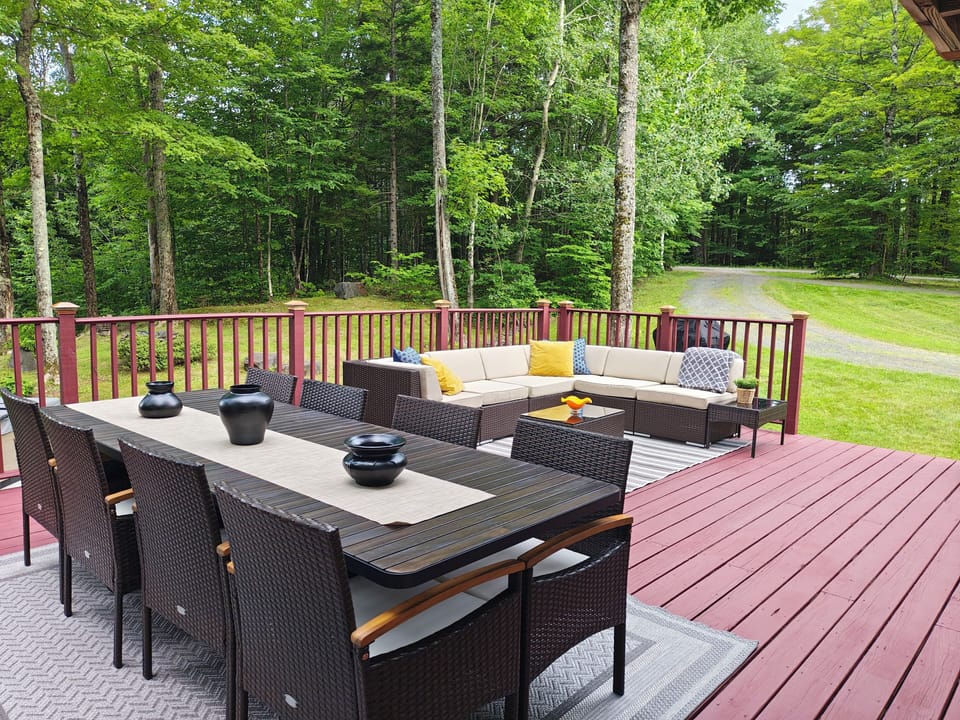 Dining and sitting area on the large deck facing the entrance to the property. 
