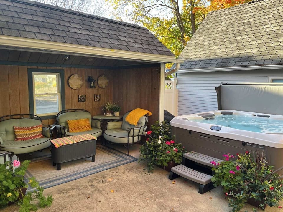 Private back yard with a seating area and a hot tub.