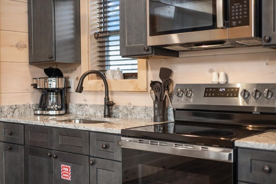 Full kitchen with drip coffee pot, microwave and stove